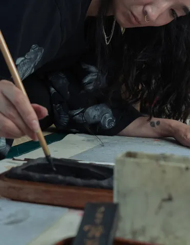 An artist working with clothing-derived paper.