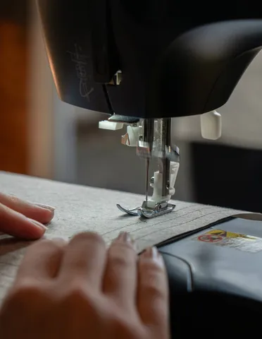 Working with the paper at a sewing machine.